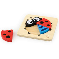 Ladybird block puzzle on light wood base with three pieces